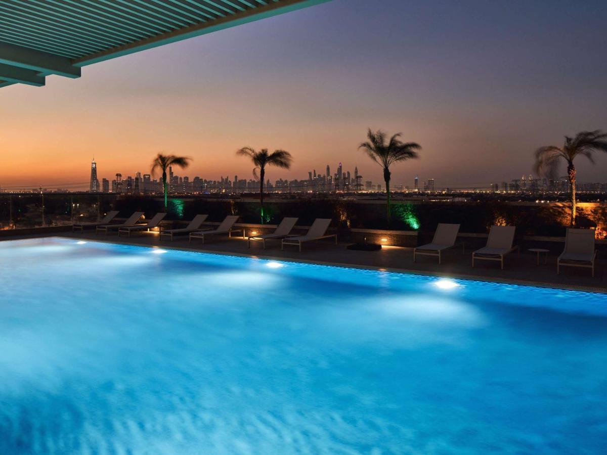 Movenpick Jumeirah Village Triangle Dubai Luaran gambar The swimming pool at the hotel
